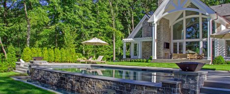 Luxury gunite pool design with retaining wall