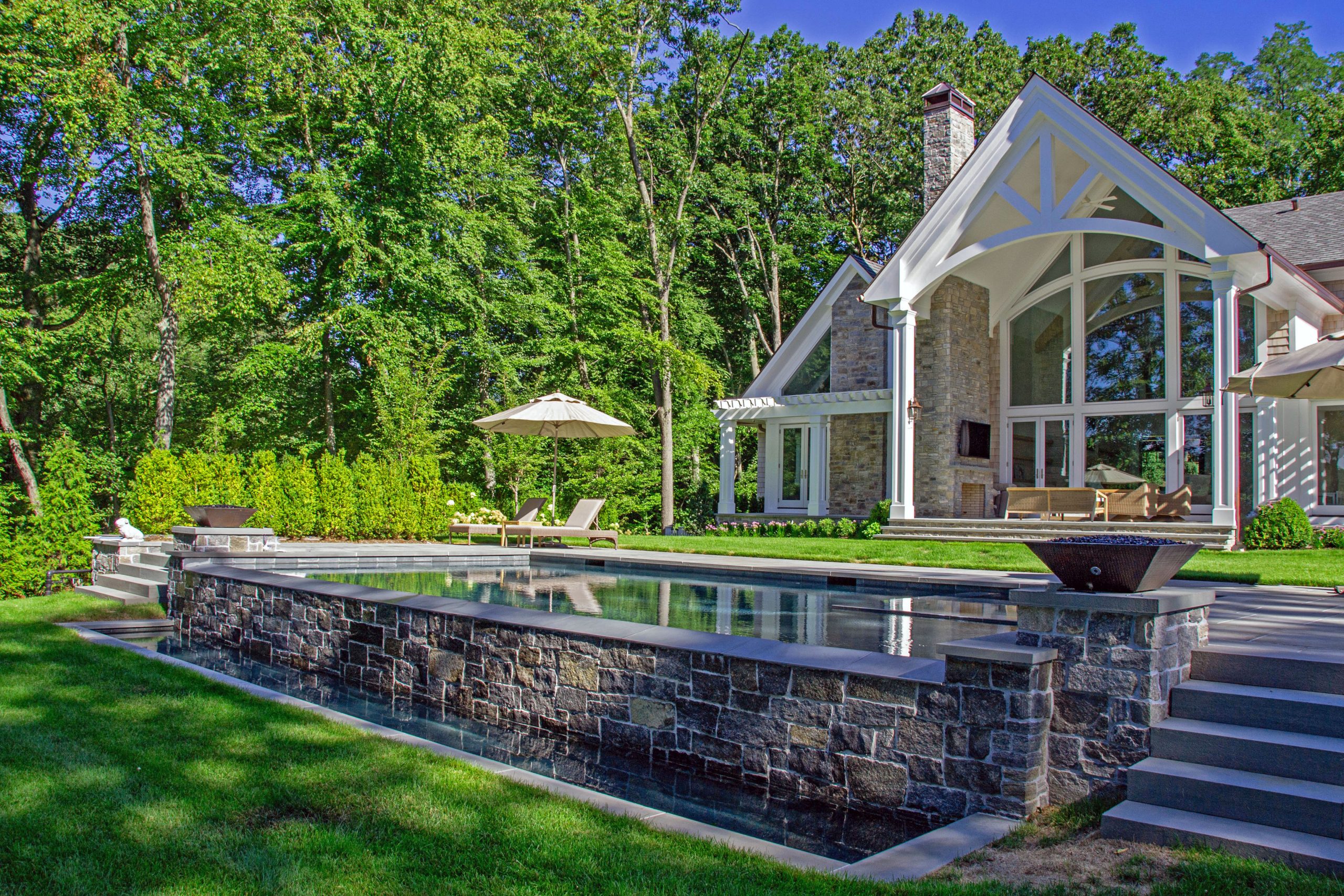 Luxury gunite pool design with retaining wall