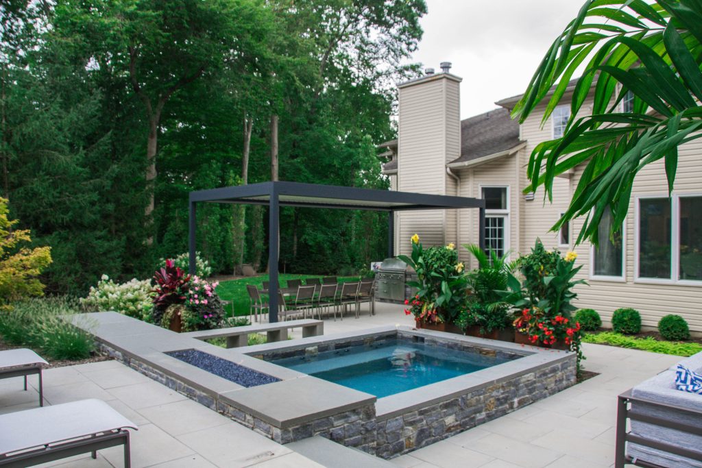 custom cocktail pool with fire feature and planters