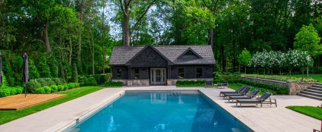Gunite geometric pool design with patio and pool cabana